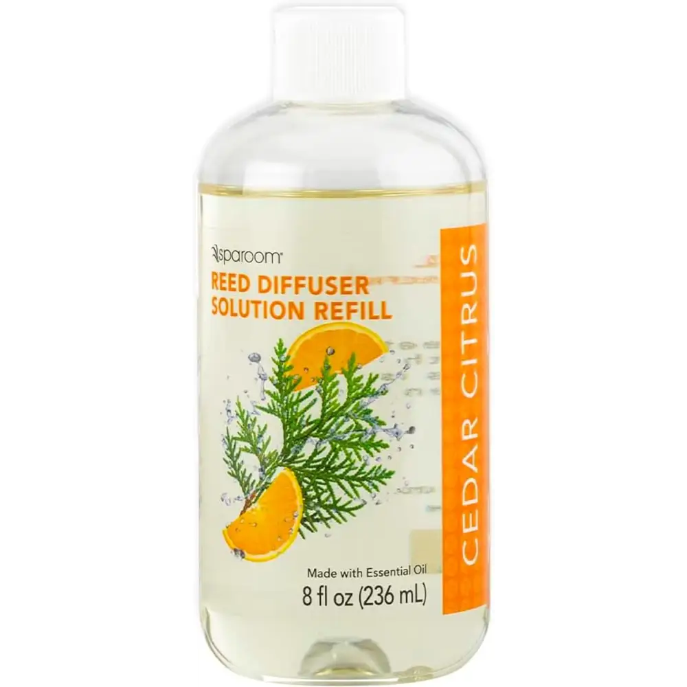 Clear bottle of Vanilla Bean Oil Reed Diffuser refill with citrus and evergreen label