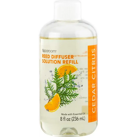 Clear bottle of Vanilla Bean Oil Reed Diffuser refill with citrus and evergreen label