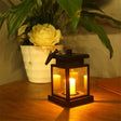 Glowing black lantern with flickering candle in Waterproof LED Solar Outdoor Garden Lamp