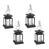 Four black waterproof LED solar lanterns with glass panels for outdoor use