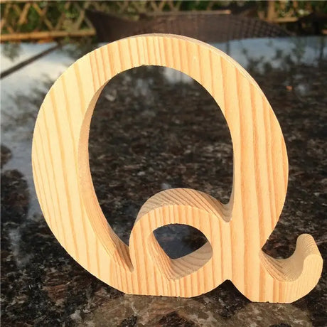 Wooden letter Q in decorative cursive design for home decor or perfect gift option