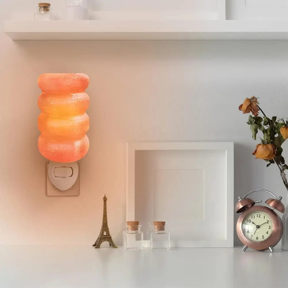 Pink Himalayan salt lamp illuminating a Wooden Headboard Bed with Himalayan salt night light