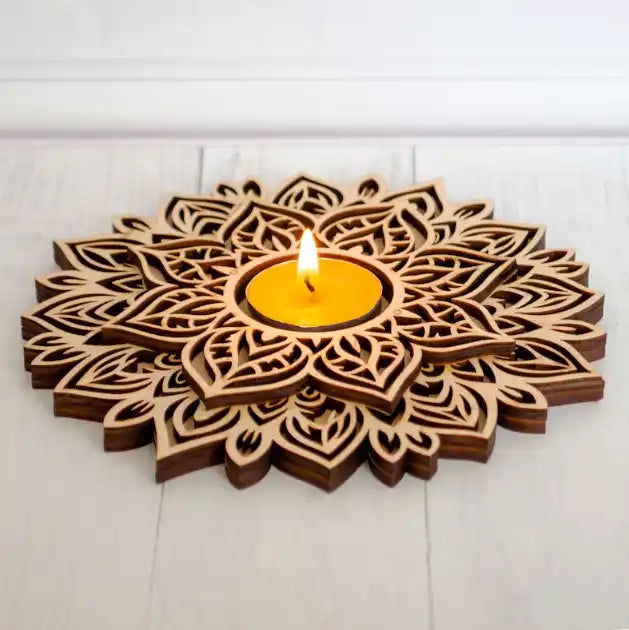 Wooden mandala-style candle holder with intricate laser-cut patterns holding a lit yellow candle.