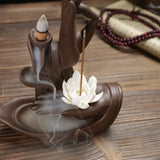 Ceramic incense burner in Buddha hand design with lotus flower and rising smoke